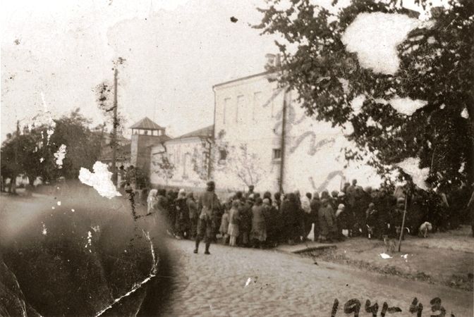 German guards oversee the assembly of Jews in Kamenets-Podolsk prior to their transportation to a site outside of the city for execution